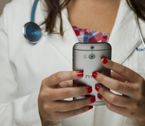 female doctor holding a cell phone